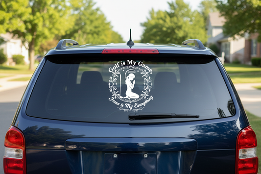 White vinyl decal on dark vehicle rear window showing praying woman golfer silhouette with Golf is My Game Jesus is My Everything text